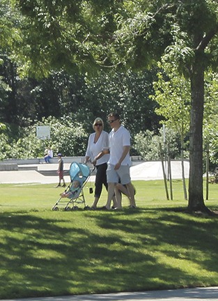 A family takes advantage of the summer sunshine in July with a walk through Mercerdale Park.