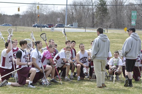 The Mercer Island boys lacrosse team listens to head coach Ian O'Hearn during a practice in Massachusetts last week.