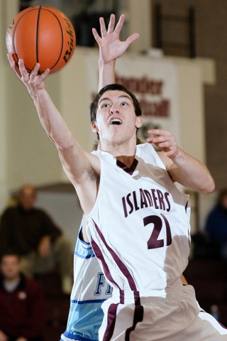 Islander guard Peter Zajac (21) drives to the basket during an exhibition game against an Australian team on Monday. Zajac led the Islanders with 14 points.