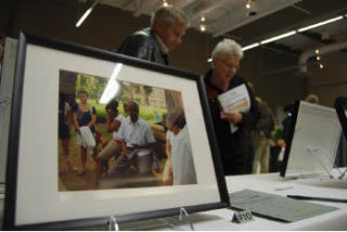 Frank and Glo Ceteznik browse over photographs taken by Mercer Island and Franklin High School students from their 2008 Multicultural Scholars tour of the Deep South. The photographs were up for silent auction at the CCMV on Nov. 16.