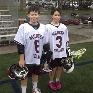 Eleven-year-old Blake Sloan (left) and Mason Bull took part in their first youth lacrosse game in the maroon and white