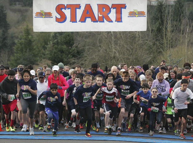 Runners take off at the start of the 5K run Sunday in the Rotary Run at the Mercer Island Community and Event Center.