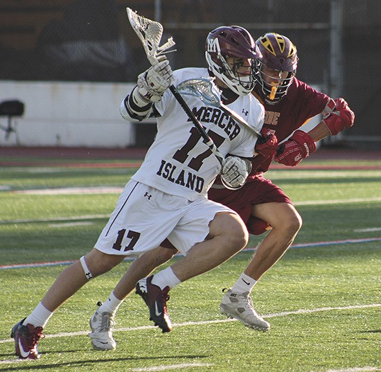Mercer Island sophomore midfielder Evan Condon collides with a player from Lakeside during the Islanders win on Tuesday