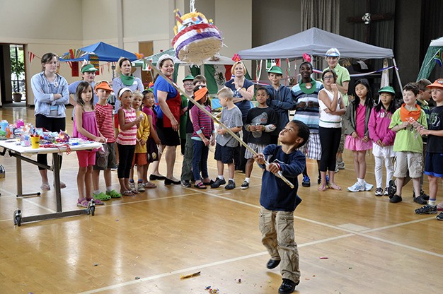 Children take swings at a piñata during Vacation Bible School at the Mercer Island Presbyterian Church on Wednesday
