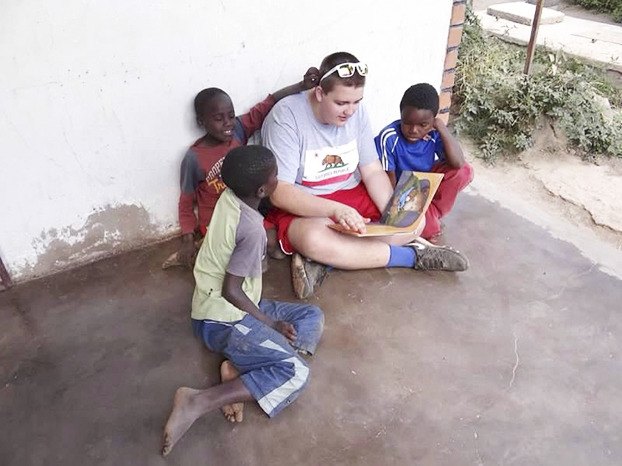 Pawlosky reads to the younger children in the morning.
