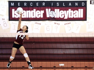Islander Janelle Chow serves during a volleyball game against Seattle Prep September 29