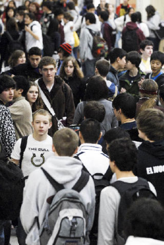 Students fill the hall during a class change at Mercer Island High School on Friday.