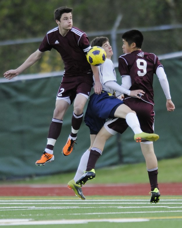 Mercer Island’s Matthew McNamara (2) and Jeremy Chow (9) go against a Bellevue player to clear a shot on the Islanders’ end of the field on Tuesday