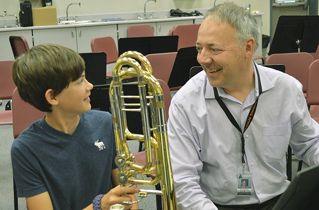 Educator and musician Dave Bentley works with a student. Bentley was named a 2015 Teacher of the Year.