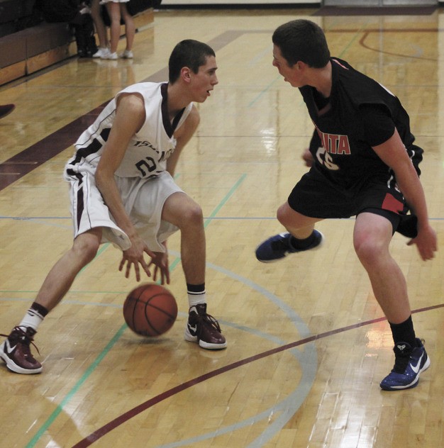 Mercer Island's Nick Nordale (22) looks to get around Juanita's Kendrick Murphy during the Islanders home win over the Rebels on Friday