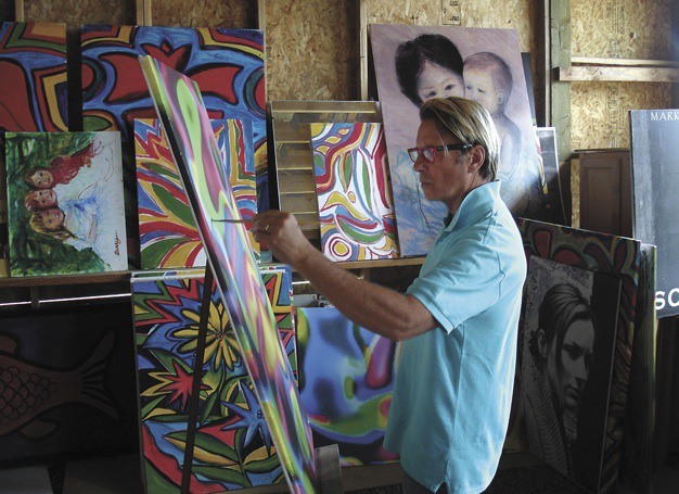 Island native Mark Berry paints in his studio in Ellensburg