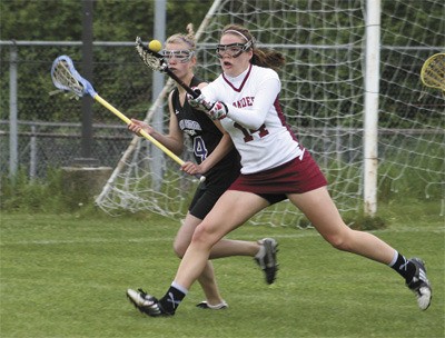 Mercer Island girls lacrosse player Ellen Haas battles for the ball during the Islanders home playoff game against Lake Sammamish on Monday