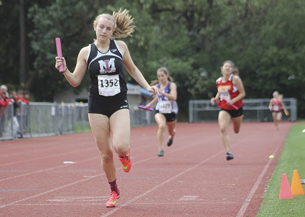 Mercer Island’s Victoria Gersch crosses the finish line after the final leg of the girls 4x200 relay during the Bellevue Invitational Saturday at Bellevue High School. Gersch helped her relay team to a fourth-place finish overall.