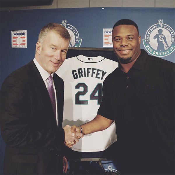 Mariners President Kevin Mather and Hall of Fame inductee Ken Griffey Jr. shake hands after the announcement that the team will retire his jersey number.