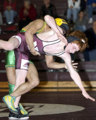 Islander Scott Mills wrestles during the first round of the Reynolds Invite. Mills scored the KingCo title clinching pin fall during the team’s meet with Woodinville.