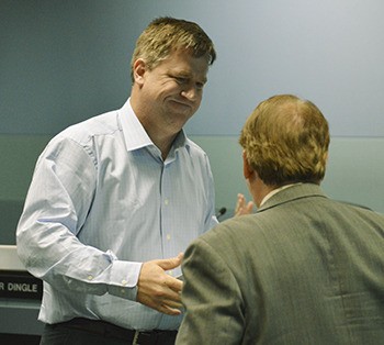 Appointed School Board member Ralph Jorgenson shakes hands with Superintendent Dr. Gary Plano after taking the oath of office Thursday