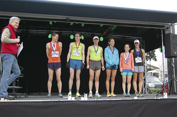 Sen. Steve Litzow hands medals to the top finishers in the Mercer Island Half marathon: Spencer Walsh