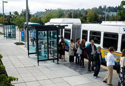 Transit riders line up for the morning commute on a Route 550 bus to Seattle at the Mercer Island Park and Ride last summer.
