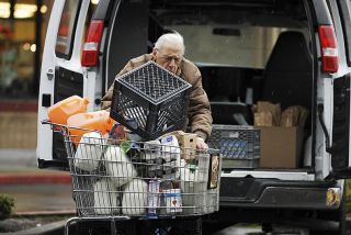 Chad Coleman/Mercer Island Reporter Islander Lou Borda picks up food donations for Friends of the Needy from Albertsons grocery on Mercer Island.