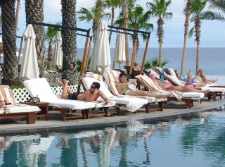 Bill Morton/Special to the Reporter Tourists read and sunbathe on the beaches of Los Cabos San Lucas on the Baha Peninsula of Mexico.