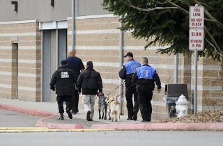 Chad Coleman/Mercer Island Reporter Washington State Patrol troopers assist with bomb-sniffing dogs after a bomb threat was called in to Mercer Island High School on Tuesday morning
