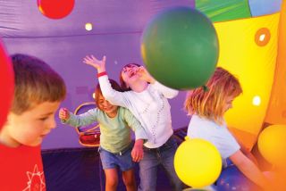 Reporter file photo Kids bounce with glee in an inflatable play area during Mercer Island’s Summer Celebration!