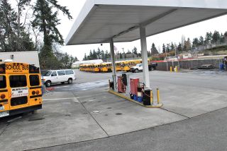 Chad Coleman/Mercer Island Reporter Buses line the Mercer Island School District bus lot that is sandwiched between the district administrative building and the Mercer Island High School football field. The district is looking at moving the facility to land behind City Hall.