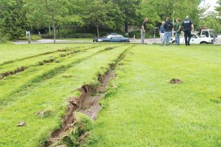 Chad Coleman/Mercer Island Reporter Tire tracks mark the field at Mercerdale Park after a high-speed police pursuit tore through the downtown Mercer Island business district Friday.