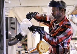 Chad Coleman/Mercer Island Reporter ‘Bio Lyle’ Rudensey pours potassium salt into his BioPro biodiesel production machine at a garage in the Madrona neighborhood of Seattle