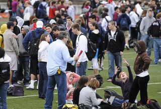 Chad Coleman/Mercer Island Reporter Students visit while they wait after being evacuated from Mercer Island High School to Islander Stadium due to a bomb threat that was called in to the school office on Feb. 26.