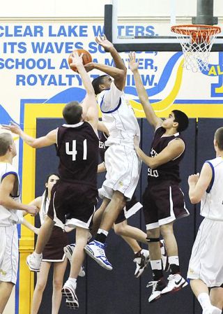 Chad Coleman/Mercer Island Reporter Islander Sam Rasmussen picks up one of his four blocks during the game.