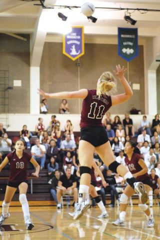 Chad Coleman/Mercer Island Reporter Islander Liz Miller (11) hammers the ball into the Bothell side of the court for a kill on Thursday at Mercer Island High School. The Islanders defeated the Cougars 3-1 and opened the season with a 3-0 victory over Seattle Prep.