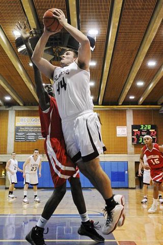 Chad Coleman/Mercer Island Reporter Mercer Island senior Jack Gala drives hard to the basket for two of his 10 points against Cleveland High School