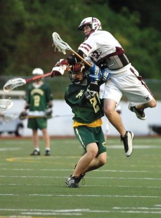 Chad Coleman/Mercer Island Reporter Islander A.J. Ellis elevates to elude a Roosevelt defenseman in order to score one of his three goals on the night on Wednesday at Islander Stadium. Mercer Island’s game against Skyline  on Tuesday will be featured on Comcast On Demand.