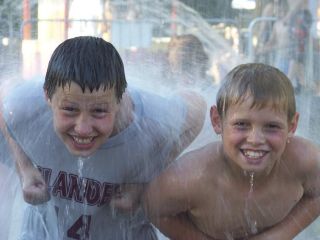 Contributed photo Islanders Josh Stenberg and Nate Schuler take time to cool off at the River Front fountain during the 2008 Spokane Hoopfest. Stenberg’s Cloud Nine team won its division by going 5-0