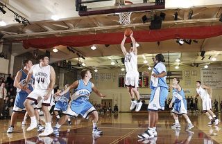 Chad Coleman/Mercer Island Reporter Mercer Island’s Leroy Lutu drives to the basket against Interlake for two of his game-high 25 points. The senior also tied a school record for steals in a game