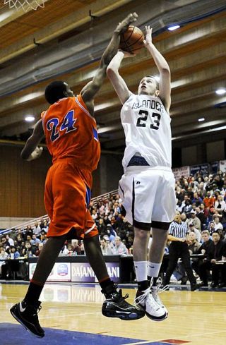 Chad Coleman/Mercer Island Reporter Islander Drew Sexton gets blocked by Beach’s Ababe Dimisse during the district championship game at Bellevue Community College