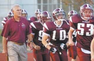 Chad Coleman/Mercer Island Reporter Former Mercer Island football coach Dick Nicholl leads his 2006 football team onto the field during the last of his 33 years on the sidelines.