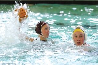 Chad Coleman/Mercer Island Reporter Islander Katie Stadius takes a shot against Shorewood on Friday at Mary Wayte Pool. Stadius scored four of the team’s 15 goals during the contest.