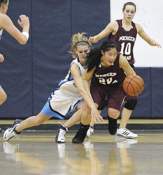 Chad Coleman/Mercer Island Reporter Mercer Island senior Janelle Chow earns a steal just before being tripped up by an Interlake player to avoid the easy basket. A Chow steal turned the tied of the game during the third period.