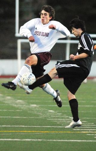 Chad Coleman/Mercer Island Reporter Islander Chris Morris blocks a Sammamish defender from clearing out a deep ball during the game at Islander Stadium Thursday.