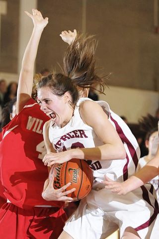 Chad Coleman/Mercer Island Reporter Islander Hannah Lilly grabs a rebound against Mount Si on Friday. Lilly finished with a double-double