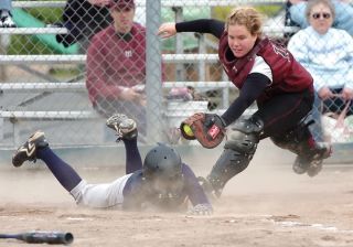 Chad Coleman/Mercer Island Reporter Mercer Island catcher Megan Cook dives to tag a Liberty runner at the plate during an 11-1 loss April 30.