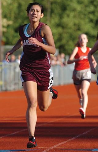 Chad Coleman/Mercer Island Reporter Islander sophomore Haley Piper pushes to the finish during the 1
