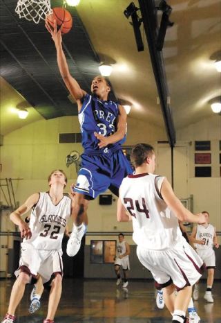 Chad Coleman/Mercer Island Reporter Islander Trevor Fulp attempts to take a charge against Seattle Prep. as teammate Matt Schut looks on Feb. 20 at Ingraham High School in Seattle.