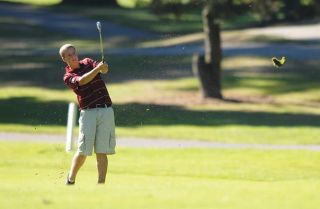 Chad Coleman/Mercer Island Reporter Islander Taylor Kettlewell takes a chunk out of Bellevue Municipal Golf Course during a match against Sammamish.