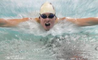 Chad Coleman/Mercer Island Reporter Islander Brian Harmon competes in the 100-yard butterfly event against Interlake at Mary Wayte Pool