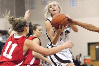 Chad Coleman/Mercer Island Reporter Islander Georgia Gier pulls down an offensive rebound against Mount Si while being double-teamed. Gier led all players during the game with 16 rebounds.