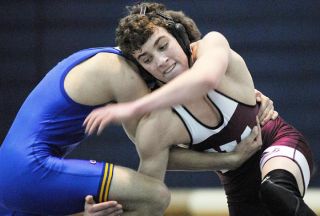 Chad Coleman/Mercer Island Reporter Islander Sam Bliss is taken off his feet during his match against Newport. Despite holding a 12-5 lead