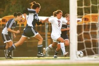 Chad Coleman/Mercer Island Reporter Islander midfielder Kara Lungmus breaks through Interlake defenders for the first goal of the game.